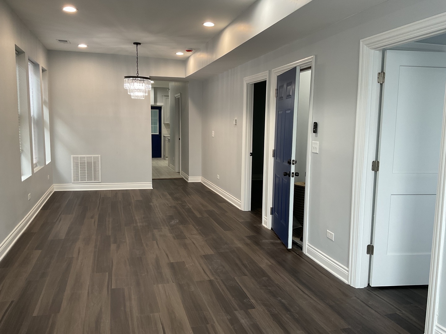 7940 South Carpenter Street, Unit 2 Chicago, IL 60620 - Photo 8 of 34 an empty room with wooden floor and windows