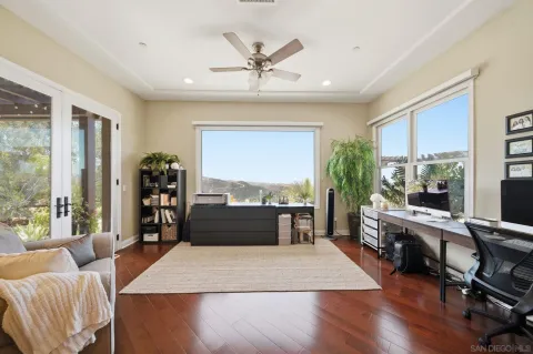 a room with furniture and view of kitchen