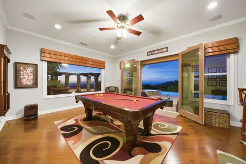 a living room with furniture fireplace and a large window