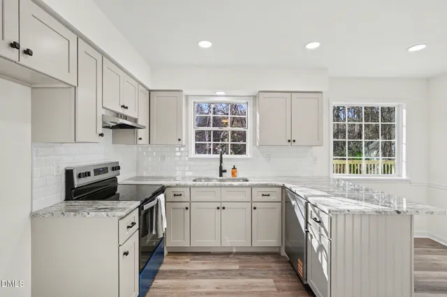a kitchen with a refrigerator and window
