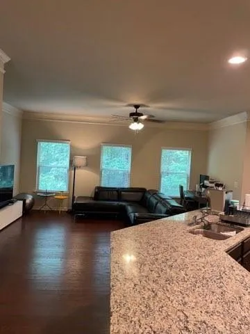 a bedroom with furniture and a large window