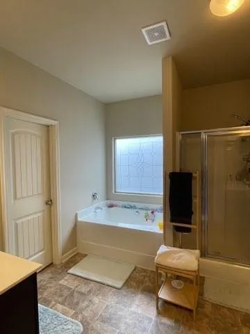 a living room with a bed furniture and a flat screen tv