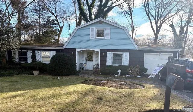 a view of a house with a yard covered in snow