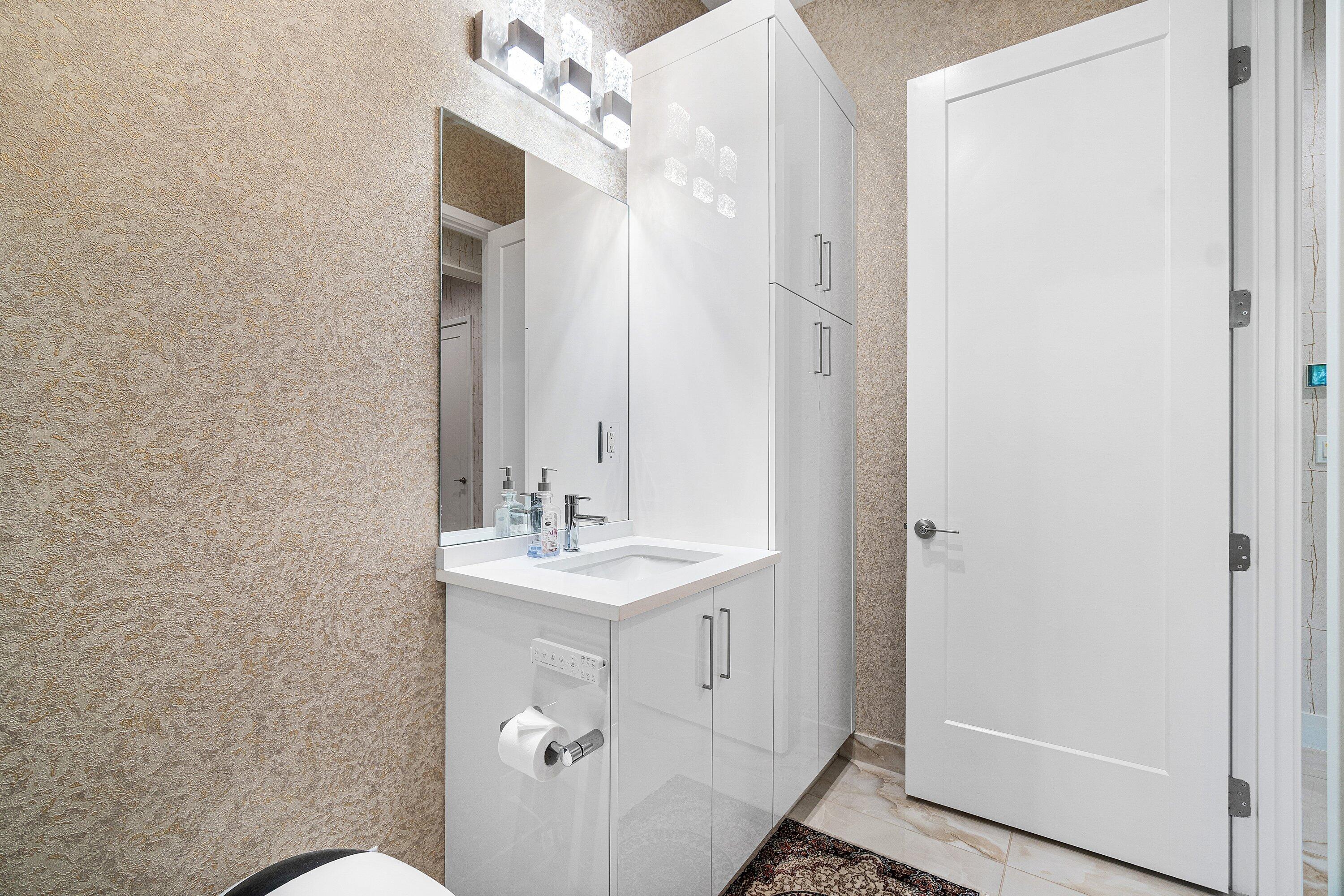 8233 Crystal Downs Avenue Boca Raton, FL 33434 - Photo 22 of 58 a bathroom with a sink mirror and vanity