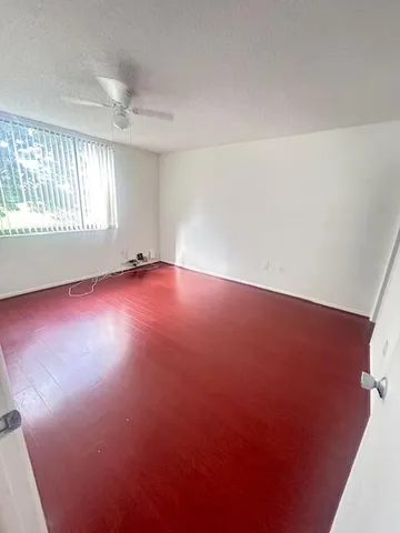 an empty room with windows and closet