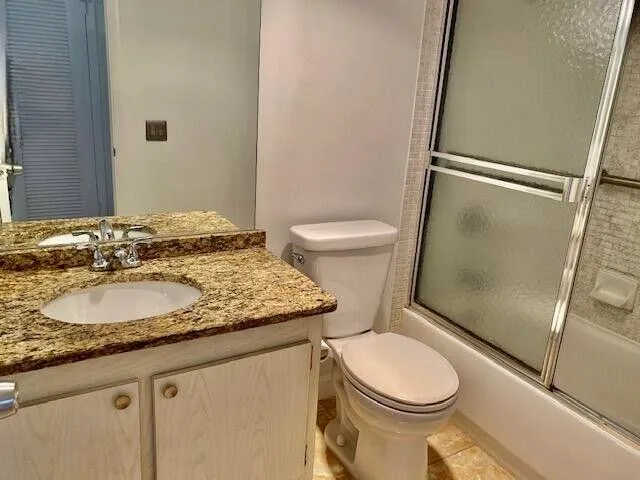 a white toilet sitting next to a bathroom sink