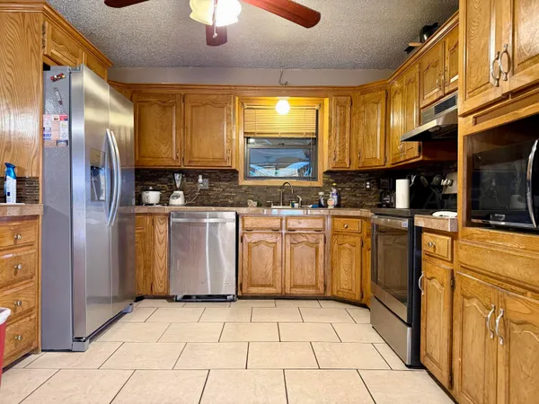 a kitchen with cabinets and stainless steel appliances