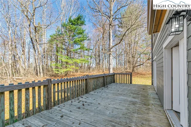 a view of a room with wooden floor and a rug