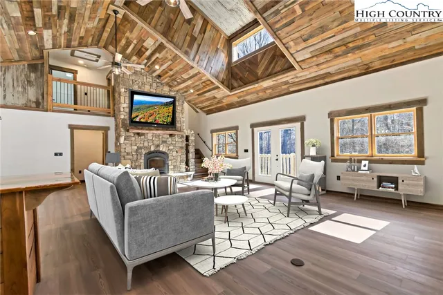 a kitchen with cabinets wooden floor and stainless steel appliances