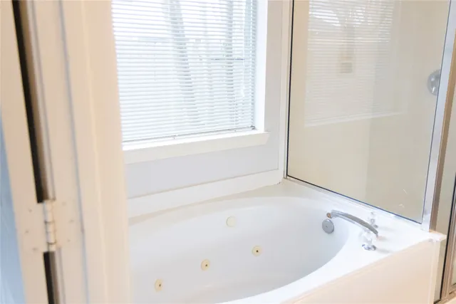 a bathroom with a bathtub and a window