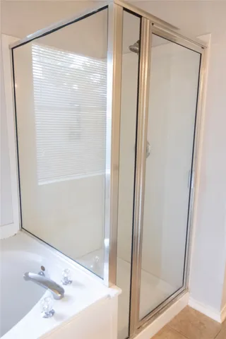 a bathroom with a shower and a sink