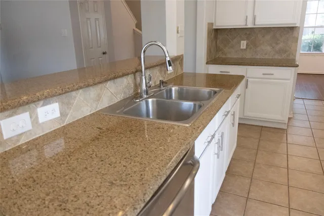 a kitchen with a sink and a stove