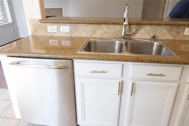 a kitchen with a sink and a refrigerator