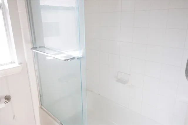 a bathroom with a glass shower door