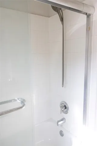 a bathroom with a shower and a bath tub