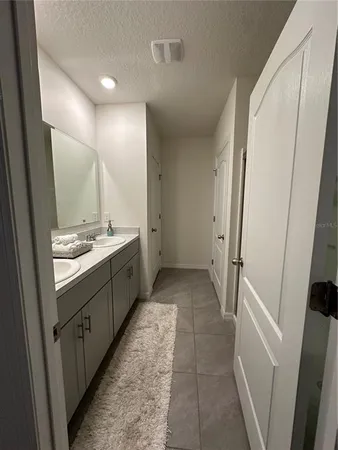 a bathroom with a double vanity sink and mirror