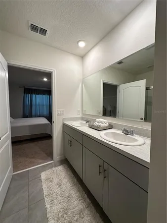 a en suite bathroom with double sink and a mirror