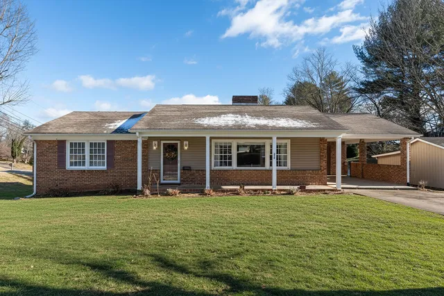 a front view of a house with a garden and porch