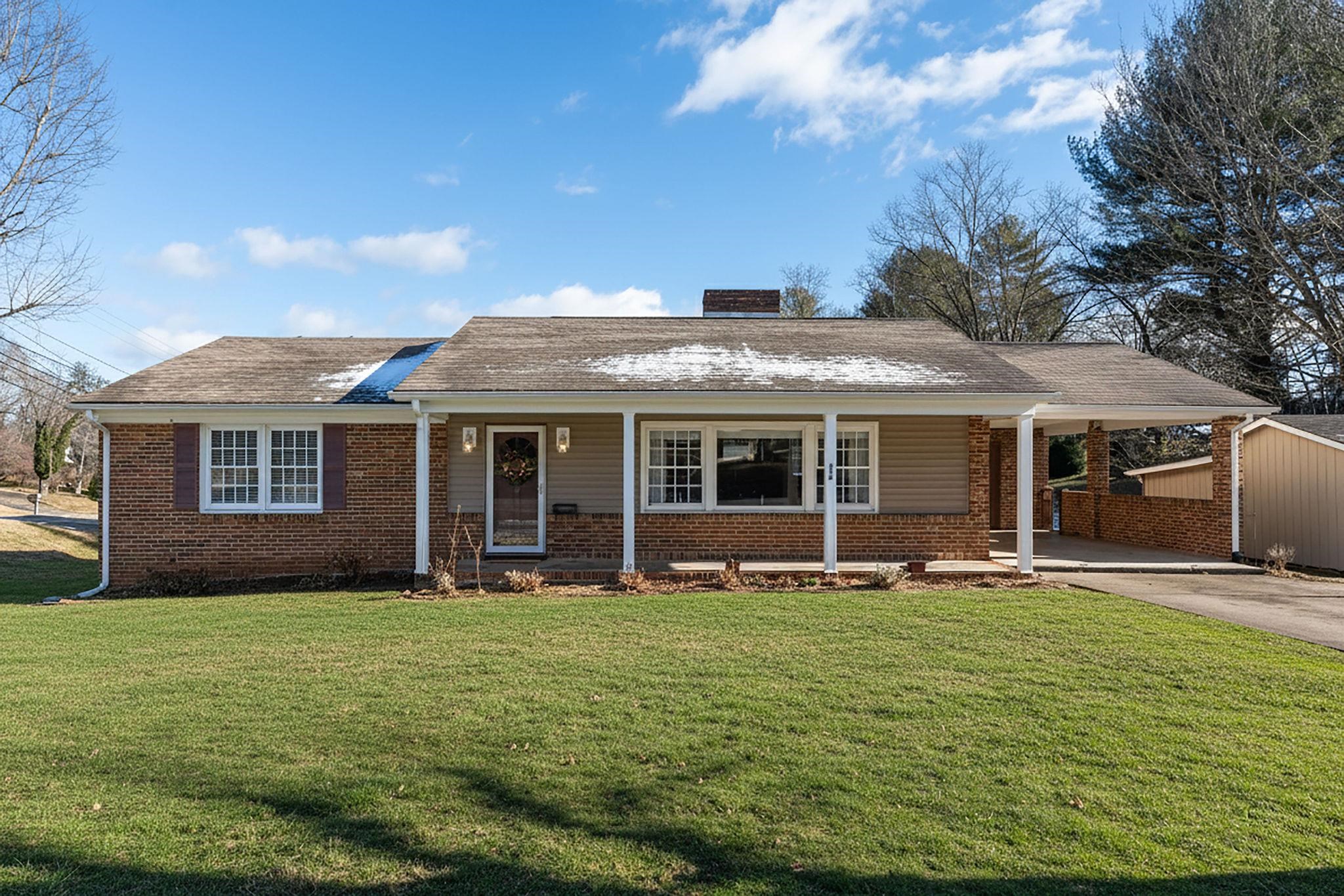 a front view of a house with a garden and porch