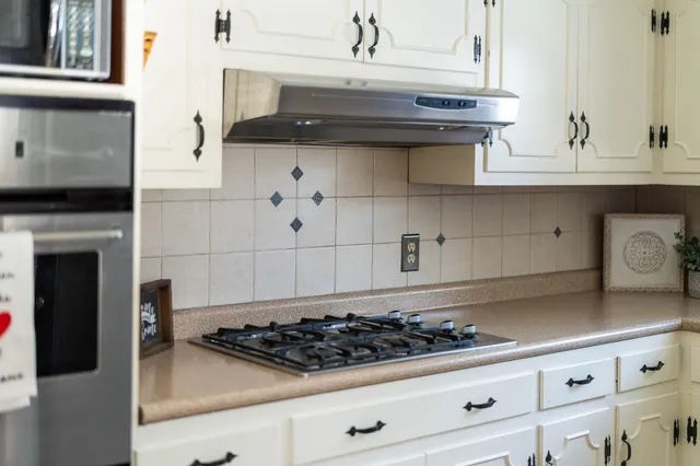 a kitchen with sink a window and cabinets