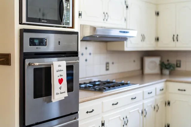 a bathroom with a sink a mirror a window and shower