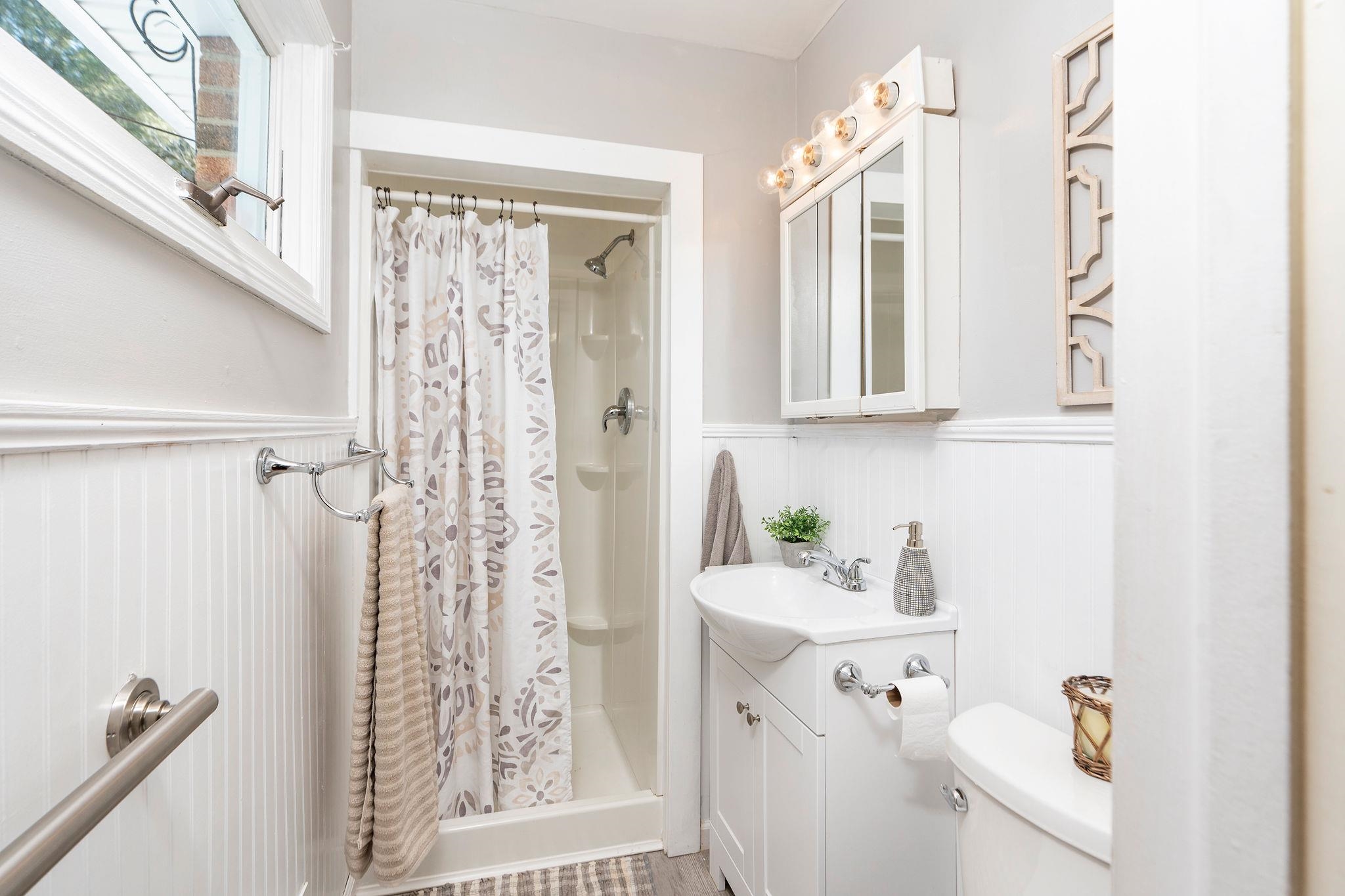 2 McCormick Street Lexington, VA 24450 - Photo 25 of 69 a bathroom with a sink a mirror a window and shower