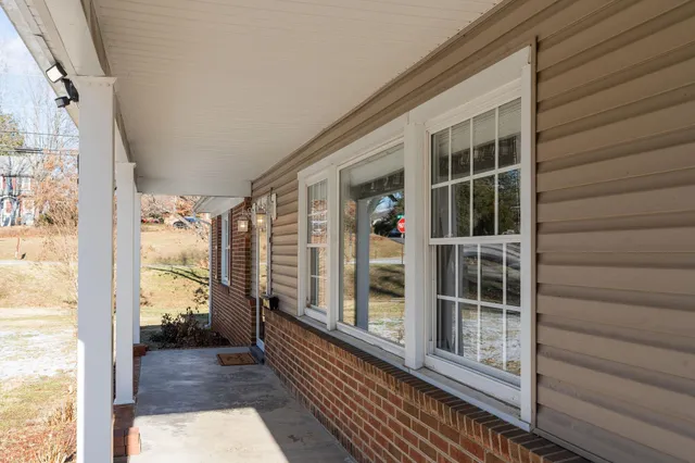a view of a hallway with wooden floor and a potted plant