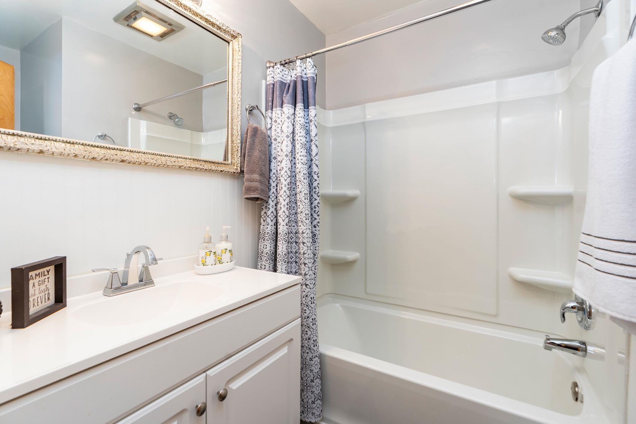2 McCormick Street Lexington, VA 24450 - Photo 31 of 69 a bathroom with a sink a mirror and a bathtub