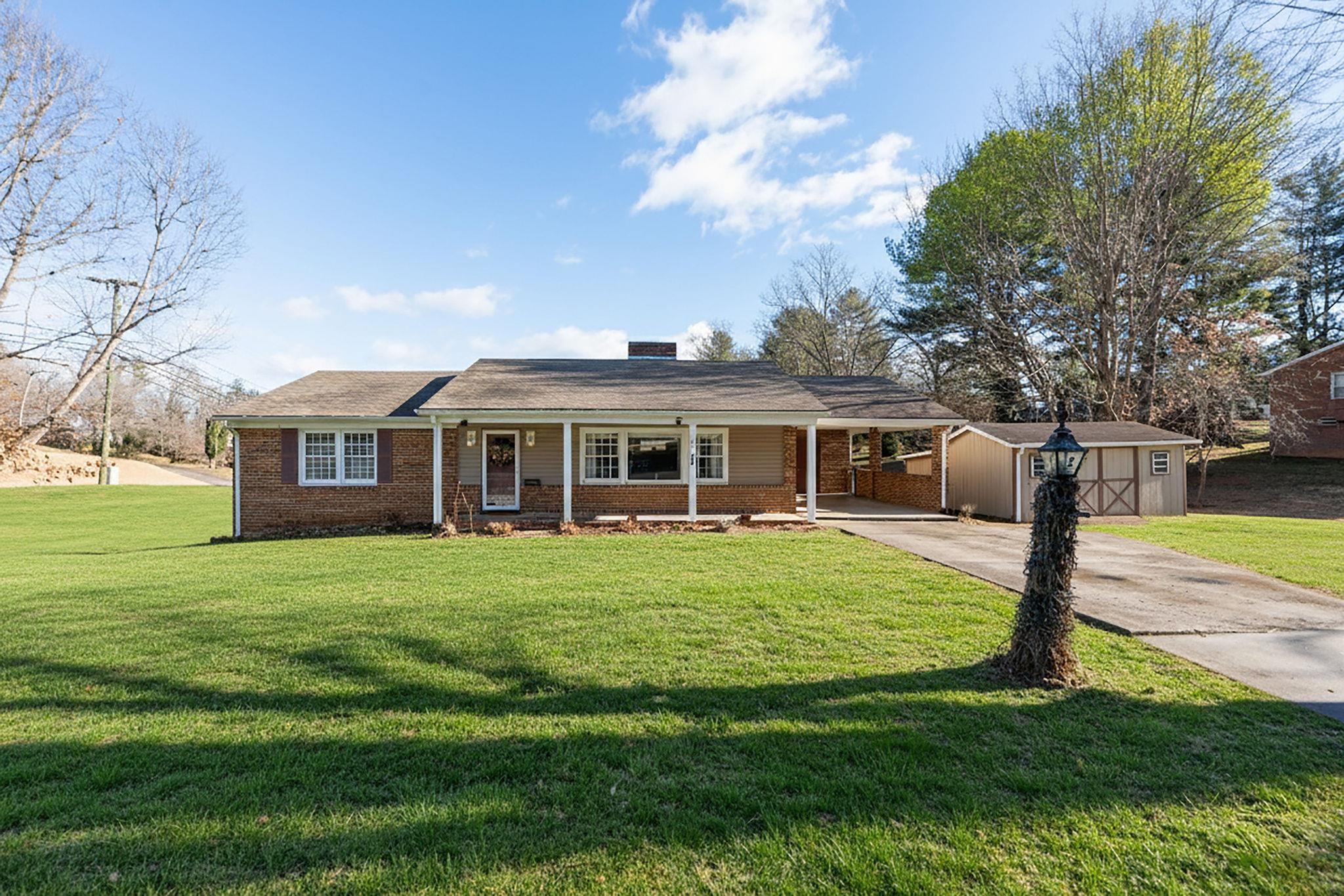 2 McCormick Street Lexington, VA 24450 - Photo 54 of 69 a front view of a house with a garden