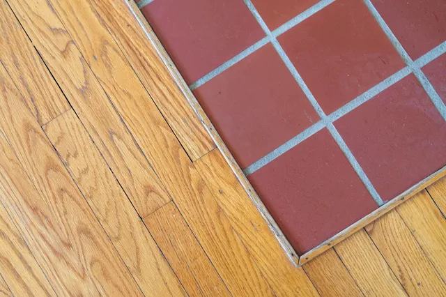 a view of empty room with wooden floor and fireplace