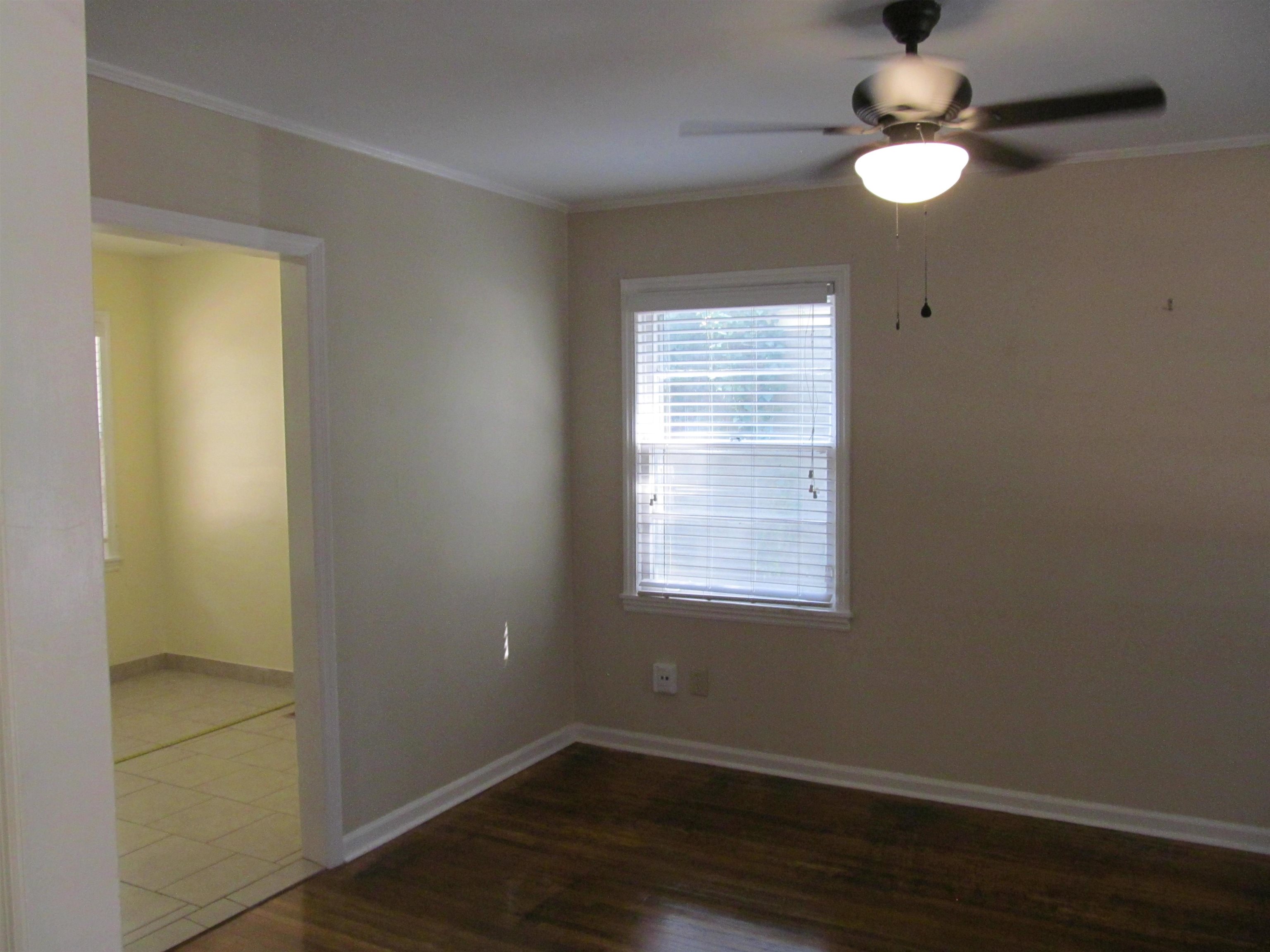1022 South White Station Road Memphis, TN 38117 - Photo 4 of 14 an empty room with wooden floor fan and window