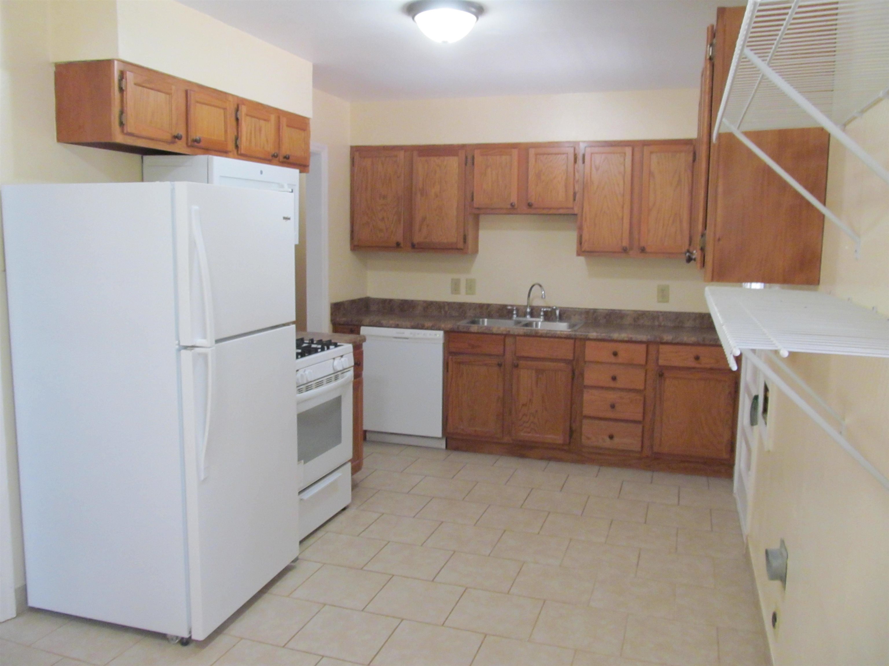 1022 South White Station Road Memphis, TN 38117 - Photo 5 of 14 a kitchen with stainless steel appliances granite countertop a refrigerator sink and cabinets