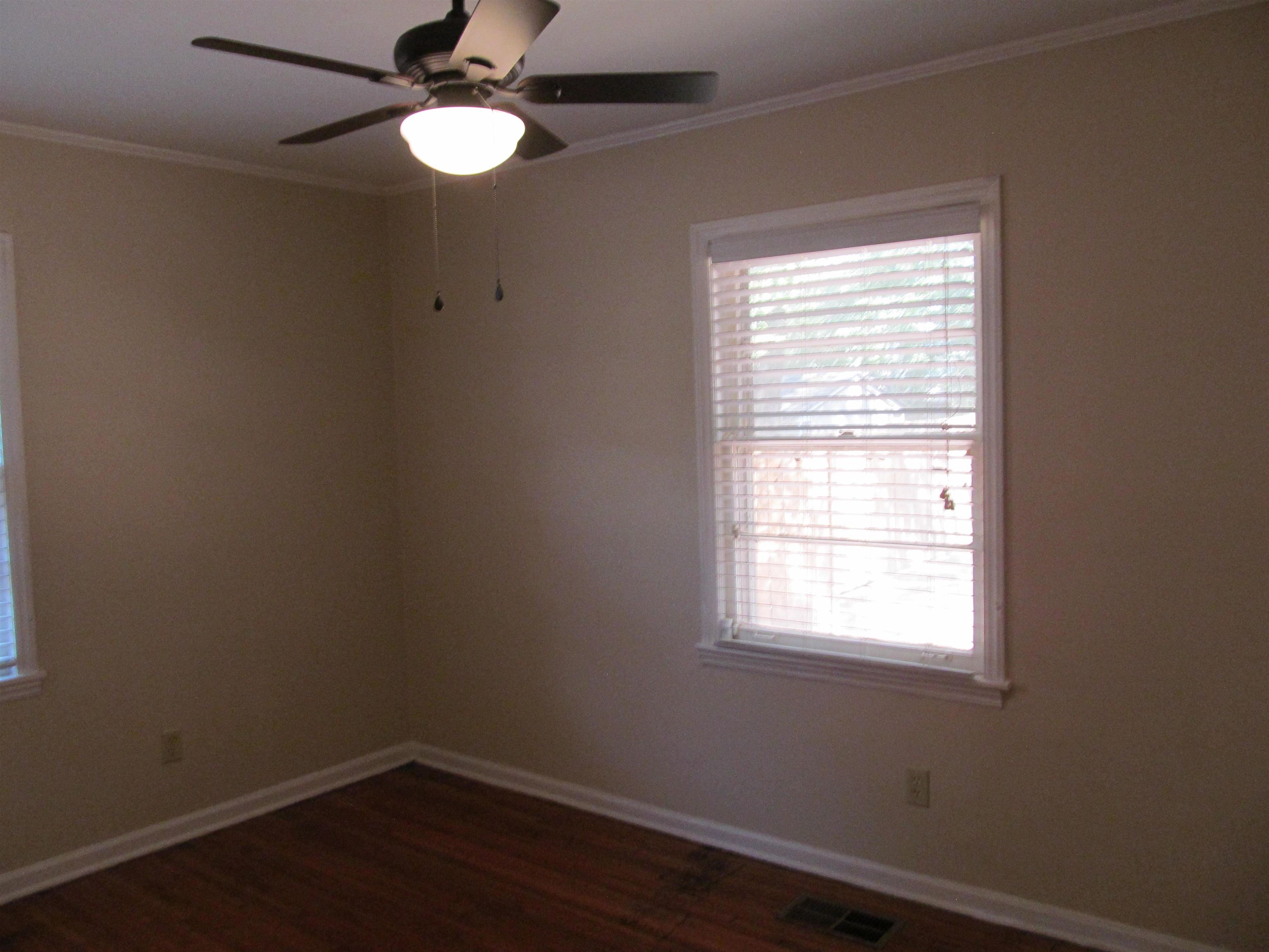 1022 South White Station Road Memphis, TN 38117 - Photo 7 of 14 a view of a room with wooden floor and windows