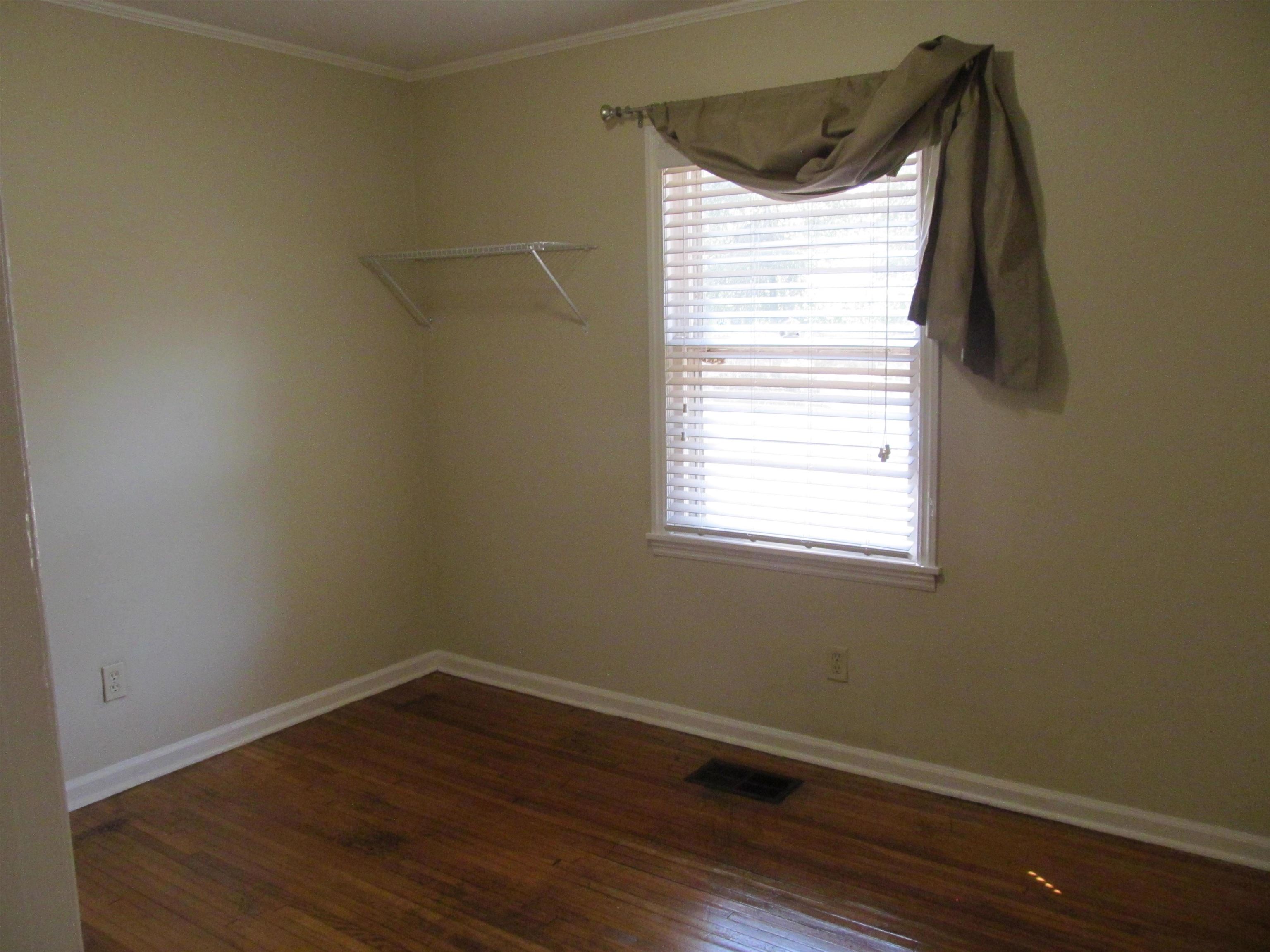 1022 South White Station Road Memphis, TN 38117 - Photo 10 of 14 a view of a small space with wooden floor and a window
