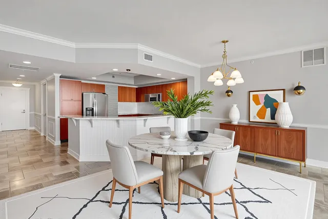 a view of a dining room with furniture and chandelier