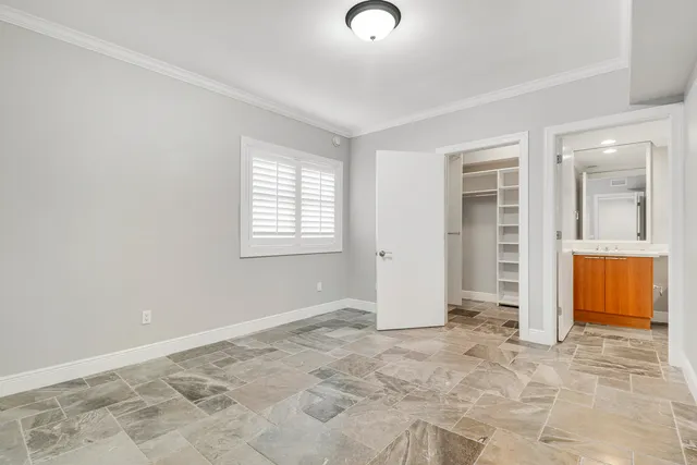 an empty room with windows and closet