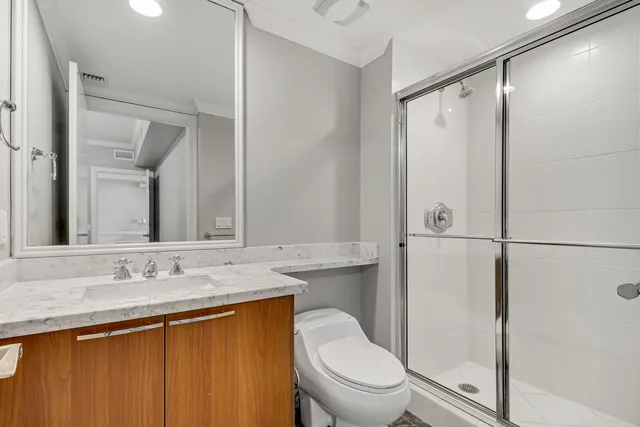 a bathroom with a granite countertop sink toilet and shower