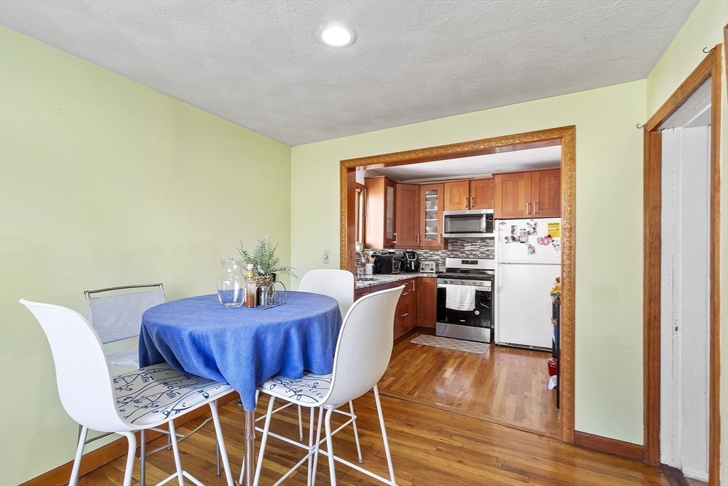 483 Broadway, Unit 1 Medford, MA 02155 - Photo 3 of 13 a view of a dining room with furniture and wooden floor