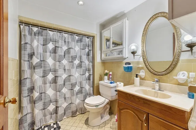 a bathroom with a sink a mirror a toilet and a mirror