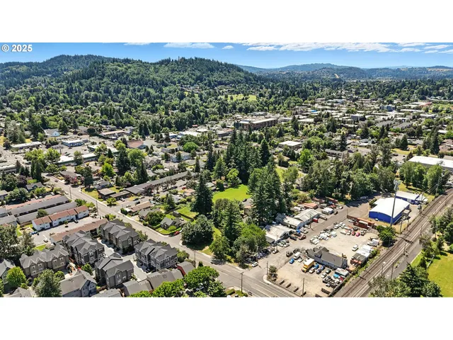 an aerial view of residential houses with city view