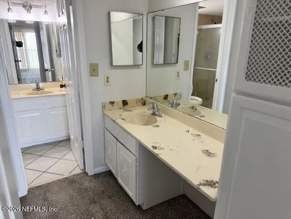 a bathroom with a sink a vanity and a mirror