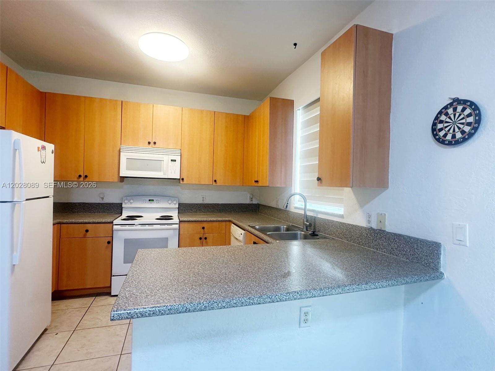 662 Northeast 21st Terrace Homestead, FL 33033 - Photo 29 of 34 a kitchen with stainless steel appliances granite countertop a sink a stove and a refrigerator