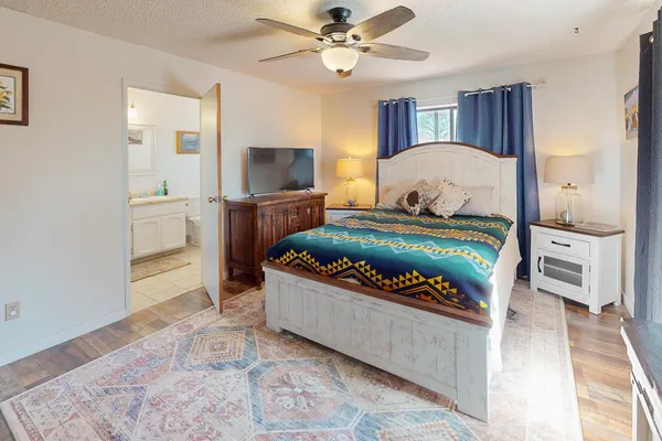 a bedroom with a bed and a chandelier