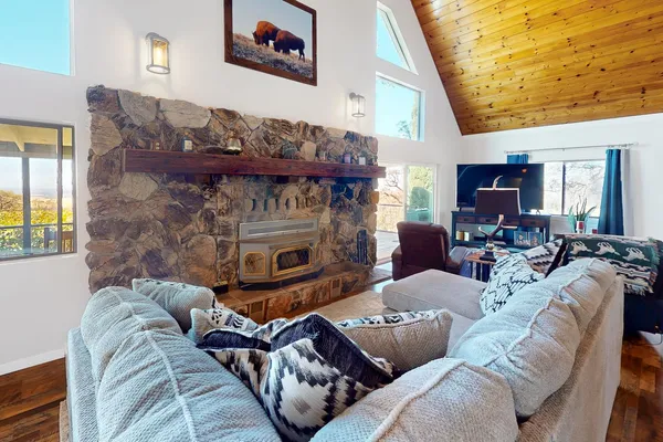 a living room with fireplace furniture and a large window