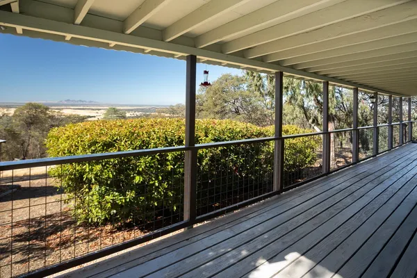 a view of a balcony with wooden floor