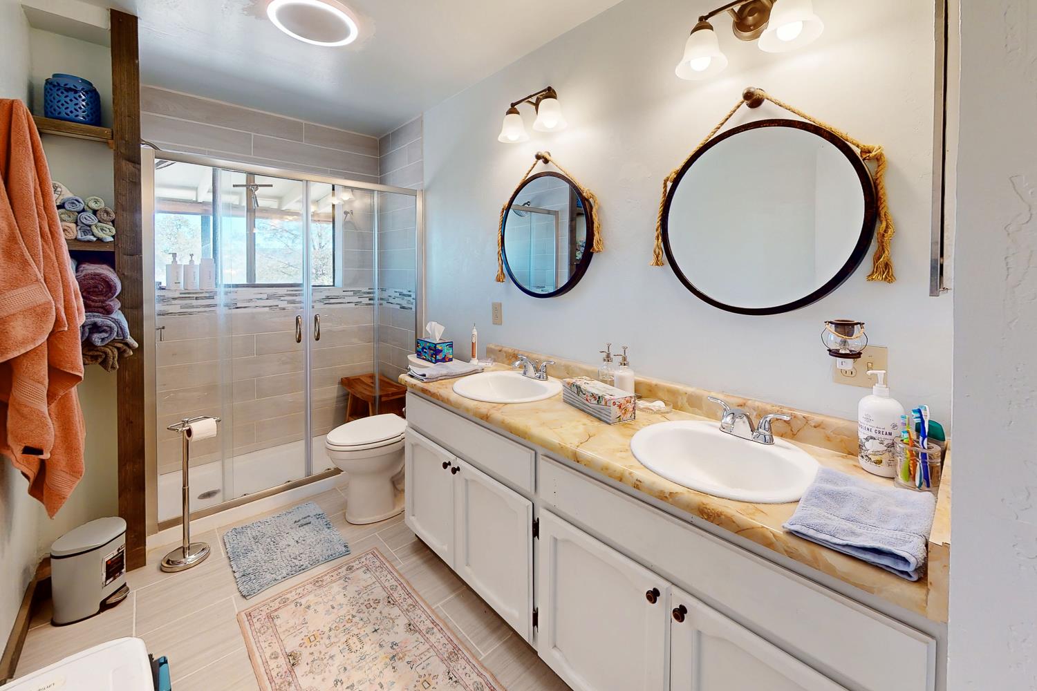 135 Sunny Hills Bangor, CA 95901 - Photo 6 of 35 a bathroom with a granite countertop toilet a sink and a mirror