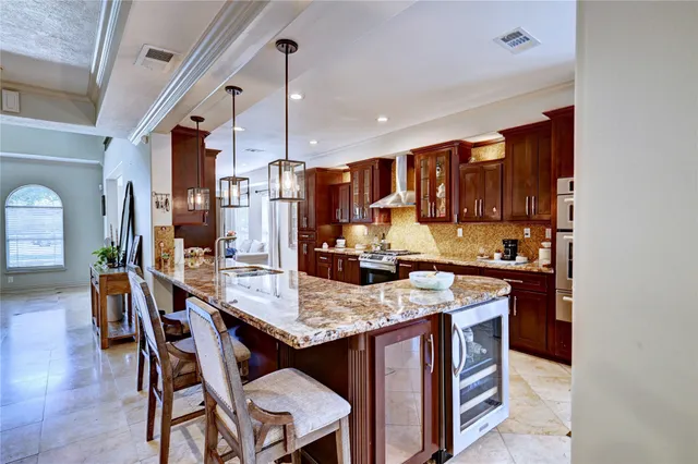 a kitchen with a stove a refrigerator and wooden cabinets