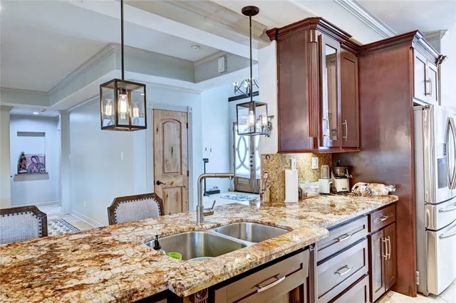 a kitchen with stainless steel appliances granite countertop a sink refrigerator and microwave