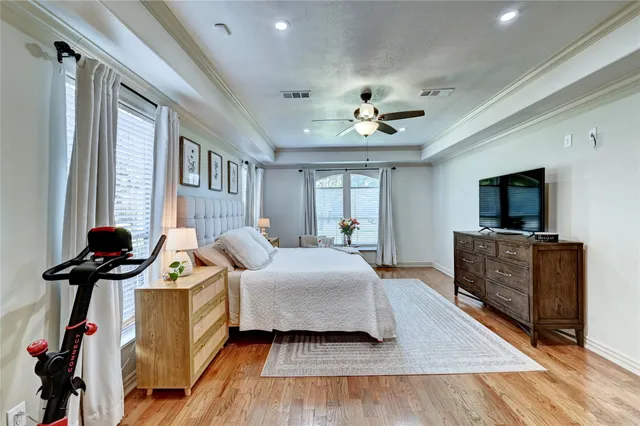 a bedroom with furniture and wooden floor