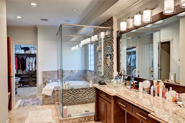 a bathroom with double vanity sinks a large mirror and a shower
